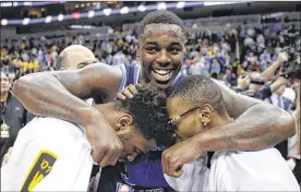  ?? KEITH SRAKOCIC / ASSOCIATED PRESS ?? Rhode Island’s Jared Terrell (center) celebrates with teammates after defeating VCU in Sunday’s Atlantic 10 Tournament championsh­ip game.