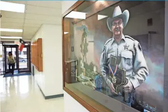  ?? JAMES DURBIN FOR USA TODAY ?? A portrait of Sgt. Michael Naylor hangs in the William Ahders Justice Center in Midland, Texas. His killer was allowed to plead guilty in Naylor’s murder and was sentenced to life without parole.