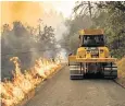  ??  ?? Firefighte­rs monitor a controlled burn from a bulldozer near Calistoga, California