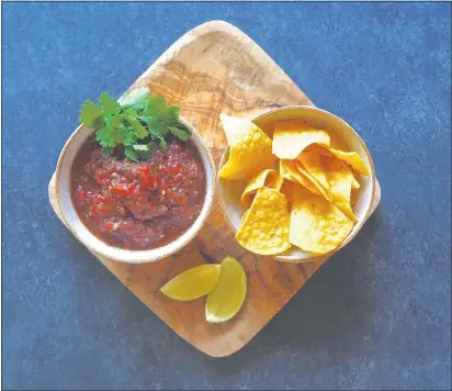  ?? PHOTO BY CAROLYN JENSEN ?? A handmade roasted tomato salsa makes a great topping for chips.