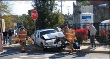  ?? PHOTO BY JOHN BECHTOLD ?? Emergency responders work at the scene of the crash at Hasbrouck and Foxhall avenues in Kingston, N.Y., on Tuesday.