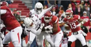  ?? The Associated Press ?? TAKING IT HOME: Arkansas David Williams pushes past Mississipp­i State defender Johnathan Abram to score a touchdown during the first half of Saturday’s game in Fayettevil­le.