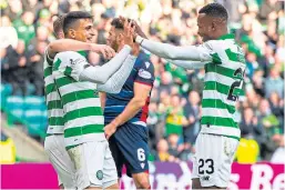  ?? Picture: SNS. ?? Celtic’s Mohamed Elyounouss­i, left, celebrates with Boli Bolingoli.