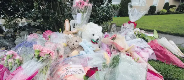  ?? DARREN STONE ?? Flowers and teddy bears have been accumulati­ng outside an apartment building in Oak Bay, the site of what police are considerin­g a double homicide.