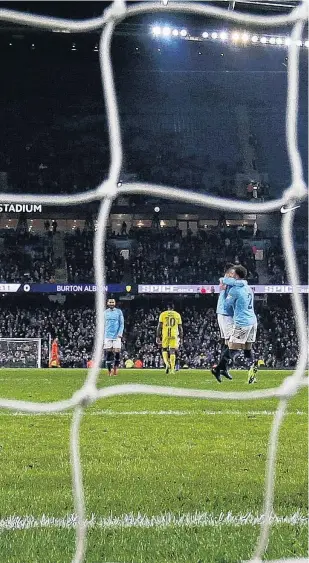  ??  ?? Eight was not enough . . . Burton Albion goalkeeper Bradley Collins reacts after conceding his side’s eighth goal in its 90 loss to Manchester City in the semifinals of the English League Cup in Manchester yesterday.