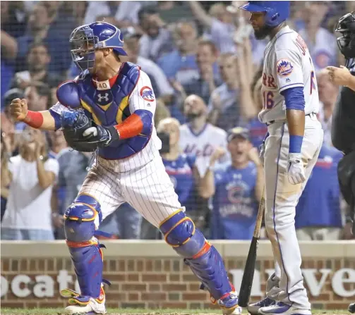  ?? JONATHAN DANIEL/GETTY IMAGES ?? Willson Contreras celebrates after Austin Jackson struck out looking with the bases loaded to end the game Monday at Wrigley Field.