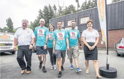  ??  ?? Alan and Sioned Jones from Sional with posties from left, Steve Jones, Bev Williams, Ben Williams and Simon Jones. Photo credit: Mike Dean (Eye Imagery).