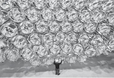  ?? Caroline Seidel / dpa / Associated Press ?? An engineer stands in front of xenon short-arc lamps in Germany’s DLR Institute for Solar Research. The lights are part of an “artificial sun” that will be used for research purposes.