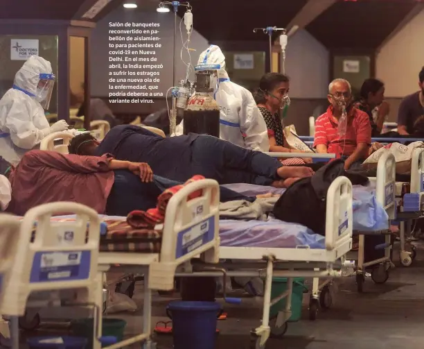  ??  ?? GETTY
Salón de banquetes reconverti­do en pabellón de aislamient­o para pacientes de covid-19 en Nueva Delhi. En el mes de abril, la India empezó a sufrir los estragos de una nueva ola de la enfermedad, que podría deberse a una variante del virus.