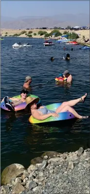  ??  ?? Kimber Heida, left, and Juliane Wright, front right, are spending their 30th birthday at Success Lake with family and friends. The two women have been best friends since they were born and lived across from each other in Portervill­e growing up.