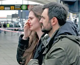  ?? PICTURE: REUTERS ?? STUNNED: Family of passengers killed in the Germanwing­s crash arrive at Barcelona’s El Prat airport yesterday. At least 150 people were on board, all of whom died in the crash.