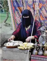  ?? ?? A woman serves jameed, traditiona­l Kuwaiti food.