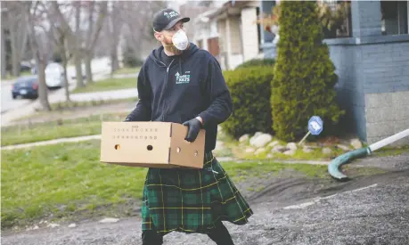  ?? DAX MELMER ?? Ben Snow, owner of Men in Kilts, delivers groceries to a home on Campbell Avenue on Friday as the COVID-19 pandemic continues to keep many people isolated in their homes. Programs for the most vulnerable, such as food banks and Meals on Wheels, were hit hard by the pandemic.