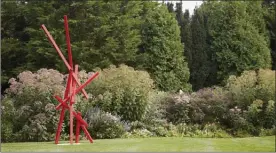  ?? The Associated Press ?? A statue by artist Joey Vaiasuso stands in a residentia­l garden on Long Island in New York.