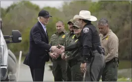  ?? EVAN VUCCI — THE ASSOCIATED PRESS ?? President Joe Biden talks with the U.S. Border Patrol and local officials as he looks over the southern border Thursday in Brownsvill­e, Texas, along the Rio Grande.