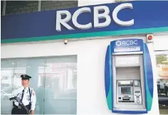  ??  ?? A security guard stands guard outside a branch of Rizal Commercial Banking Corporatio­n (RCBC) in Paranaque city, Metro Manila, Philippine­s. Bangladesh’s central bank has asked the Federal Reserve Bank of New York to join a lawsuit it plans to file...