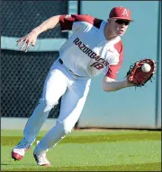 ?? NWA Democrat-Gazette/ANDY SHUPE ?? fields a ball during the Razorbacks’ 4-0 victory over Southern Cal on Friday at Baum Stadium in Fayettevil­le.