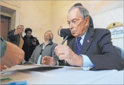  ?? Staton Breidentha­l The Associated Press file ?? Former New York City Mayor Michael Bloomberg fills out paperwork Nov. 12 at the state Capitol in Little Rock, Ark., to appear on the ballot in Arkansas’ March 3 presidenti­al primary. Bloomberg plans to spend up to $20 million on a voter registrati­on drive.