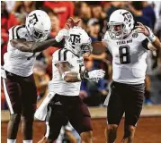  ?? Brynn Anderson / Associated Press ?? RBs Keith Ford, left, and Trayveon Williams, center, and QB Trevor Knight had a hand in win at Auburn.