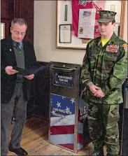  ?? CLAIRE BESSETTE/THE DAY ?? Norwich Mayor Peter Nystrom, left, reads a proclamati­on Tuesday thanking Young Marine Master Gunnery Sgt. Mason McMahon, right, for his project to raise money to purchase and design a collection box for retired flags, placed on the first floor of City Hall.