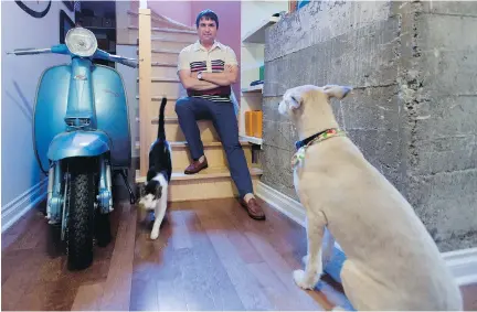  ?? PHOTOS: ALLEN MCINNIS ?? Patrick Foisy sits next to one of his three scooters along with pets Ninja and Jedi.