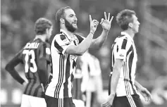  ??  ?? Juventus’ forward Gonzalo Higuain from Argentina celebrates after scoring during the Italian Serie A football match AC Milan Vs Juventus on October 28, 2017 at the ‘Giuseppe Meazza’ Stadium in Milan. - AFP photo