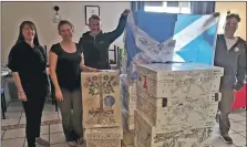  ?? ?? The Mid Argyll Saltire held aloft at the women’s care centre where baby boxes were delivered .