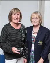  ??  ?? Gillian Merllon is presented with her fourth place prize in the Lady President’s Prize competitio­n at Blainroe Golf Club from Lady President Bernie Nelson.