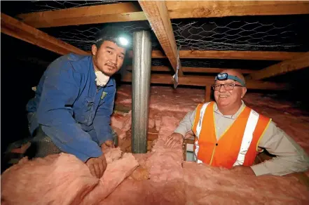  ?? MARTIN DE RUYTER/STUFF ?? AbsoluteEn­ergy managing director Paul Brockie, right, with staff member Johnsy Johnsy in the ceiling space of a home being insulated by the company. Johnsy is a former refugee of Chin ethnicity.