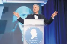  ?? SAIT SERKAN GURBUZ/ASSOCIATED PRESS ?? Supreme Court Associate Justice Neil Gorsuch speaks at a Federalist Society dinner Nov. 16 in Washington. Gorsuch reaffirmed his commitment to originalis­m and textualism before the friendly crowd.