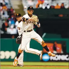  ?? RANDY VAZQUEZ — STAFF PHOTOGRAPH­ER ?? Giants shortstop Mauricio Dubon throws out a Miami Marlins runner at first base during the seventh inning of Sunday afternoon’s game at Oracle Park.