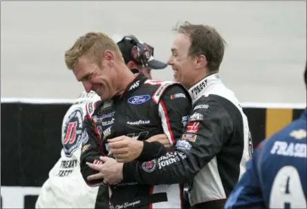  ?? AP PHOTO/NICK WASS ?? Clint Boyer, left, and Kevin Harvick, right, joke around during a weather delay during the NASCAR Cup series auto race, Sunday, May 6, 2018, at Dover Internatio­nal Speedway in Dover, Del.