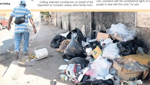  ?? JERMAINE BARNABY ?? Mark Golding This man was seen walking past a big pile of garbage on Hanover Street in Kingston last week.