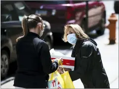  ?? MATT ROURKE — THE ASSOCIATED PRESS ?? Nita Weightman, right, brings diapers and food for curbside pickup to a family in need in Philadelph­ia, Tuesday, April
21, 2020. The Nutritiona­l Developmen­t Services of the Archdioces­e of Philadelph­ia partnered with The City of Philadelph­ia to distribute the diapers which were provided by the Greater Philadelph­ia Diaper Bank and Mitzvah Circle.