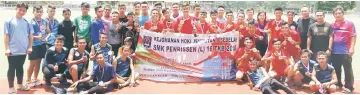  ??  ?? Champions SMK Paku in the red jerseys and runners-up SMK Penrissen No.1 pose with (from right) Kangot, Celestine Michael and Jeremy.