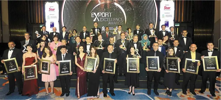 ?? ?? A night to remember: award winners with (back row, from left, without trophies) mohd mustafa, yeow, Chor, Lokman, Chia, mak and Kuan at the export excellence awards 2022 Gala Nights at m resorts and Hotel in Kuala Lumpur. also present is SMG chief content officer esther Ng (second row, second from left). — azhar mahfof/the Star