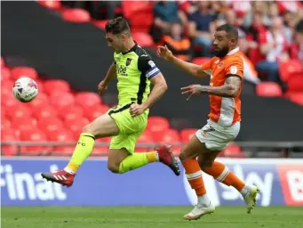  ??  ?? Kyle Vassell puts pressure on Jordan Moore-Taylor (Getty)