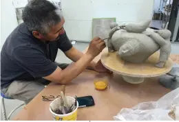  ??  ?? Pierre Aupilardju­k at work on a ceramic vessel at Medalta, 2016 ↓