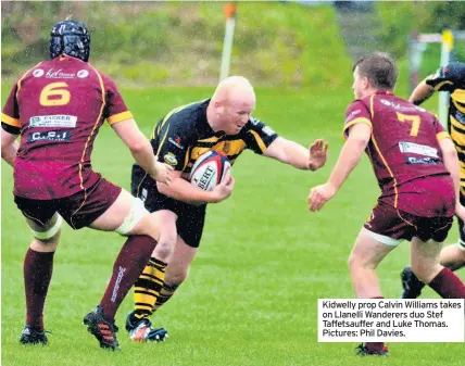  ??  ?? Kidwelly prop Calvin Williams takes on Llanelli Wanderers duo Stef Taffetsauf­fer and Luke Thomas. Pictures: Phil Davies.