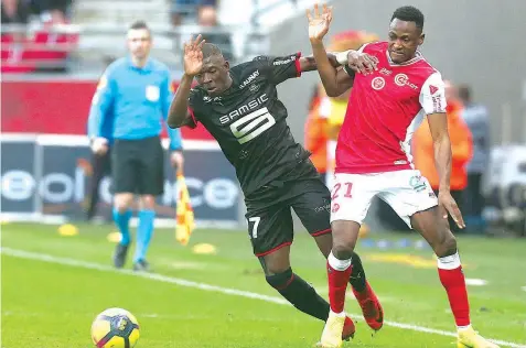  ??  ?? Reims' defender Abdul Rahman Baba (right) vies with Rennes defender Hamari Traoré during the French L1 match at the Auguste Delaune stadium in Reims… yesterday. PHOTO: AFP