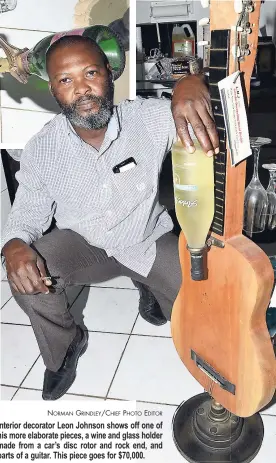  ?? NORMAN GRINDLEY/CHIEF PHOTO EDITOR ?? Interior decorator Leon Johnson shows off one of his more elaborate pieces, a wine and glass holder made from a car’s disc rotor and rock end, and parts of a guitar. This piece goes for $70,000.