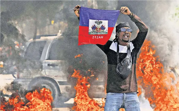  ?? ?? Protests rage in Port-au-prince; weapons destined for Haiti seized en route by US authoritie­s, left; the gang leader Barbecue, who has orchestrat­ed much of the current crisis, below