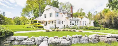  ?? Photos by Houlihan Lawrence ?? Above: Described by the listing agent as having “Old World elegance,” the colonial built in 1900 at 10 Golf Club Road is on a 1.28-acre lot overlookin­g the course at Greenwich Country Club. Below: The renovated home features wide-planked hardwood flooring.