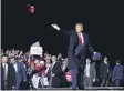  ?? ALEX BRANDON — AP PHOTO, FILE ?? President Donald Trump throws hats to supporters after speaking at a campaign rally at Duluth Internatio­nal Airport in Duluth, Minn.