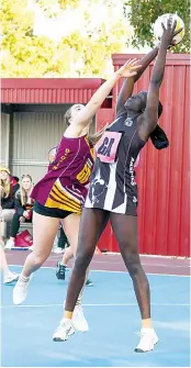  ?? Photograph­s by CRAIG JOHNSON. ?? Right: Drouin defender Kelly Mills does her best to impact the high ball into Sale goaler Dee Dee Lambert during the A grade game.