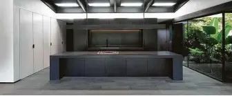  ??  ?? The spacious kitchen has a 16-foot island topped with Absolute Black granite.