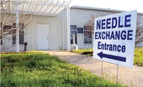  ??  ?? AUSTIN, Indiana: In this April 4, 2015 file photo, a sign points to the entrance of the Community Outreach Center. — AP