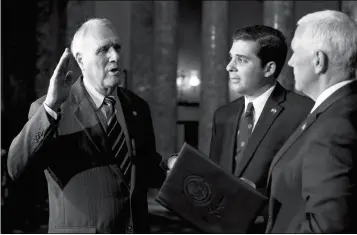  ?? ASSOCIATED PRESS ?? VICE PRESIDENT MIKE PENCE (right) administer­s the oath of office to Sen. Jon Kyl, R-Ariz., while his grandson Christophe­r Gavin holds a Bible during a ceremonial swearing-in at the Old Senate Chamber on Capitol Hill in Washington Wednesday.