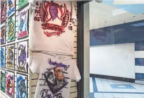 ?? BRAD VEST/THE COMMERCIAL APPEAL ?? Memorial T-shirts are on display at Tim Tarver’s Air Kingz shop at Southland Mall. Tarver says, “The RIP shirts are a big part of my business because everybody wants to be remembered.”