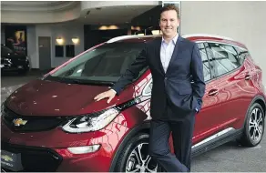  ??  ?? Travis Hester, president and managing director of General Motors Canada Co., poses with the all-electric 2018 Chevrolet Bolt EV.